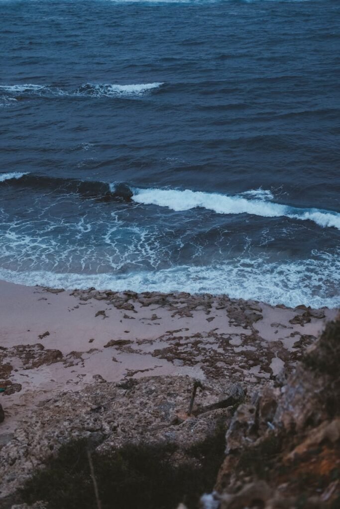 A serene beach landscape with waves crashing on the shore in Rabat, Morocco.